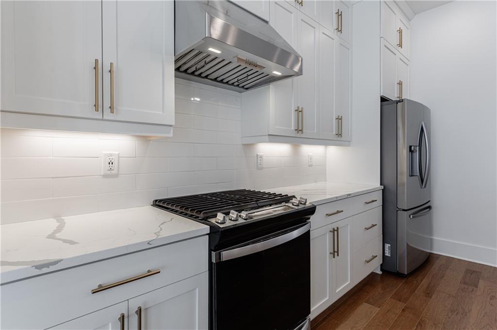 1032 Robert Smalls Way Atlanta, GA 30318 - Photo 24 of 74 a kitchen with stainless steel appliances granite countertop a sink stove and refrigerator