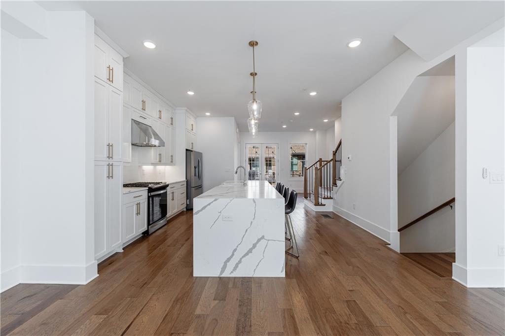 1032 Robert Smalls Way Atlanta, GA 30318 - Photo 26 of 74 a living room with stainless steel appliances kitchen island hardwood floor and a view of kitchen