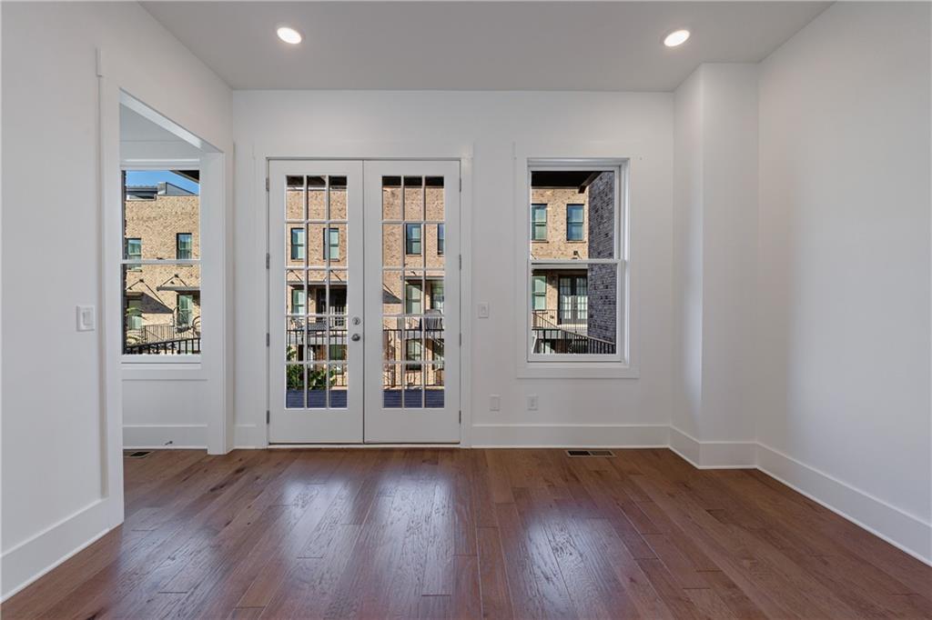 1032 Robert Smalls Way Atlanta, GA 30318 - Photo 30 of 74 an empty room with wooden floor and windows