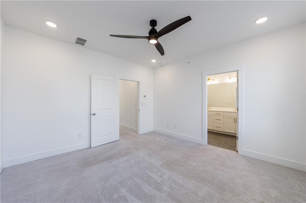 1032 Robert Smalls Way Atlanta, GA 30318 - Photo 40 of 74 an empty room with a ceiling fan & windows