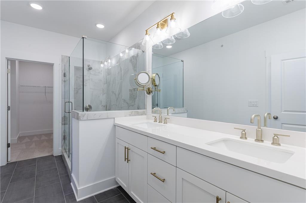 1032 Robert Smalls Way Atlanta, GA 30318 - Photo 41 of 74 a bathroom with a double vanity sink mirror and shower
