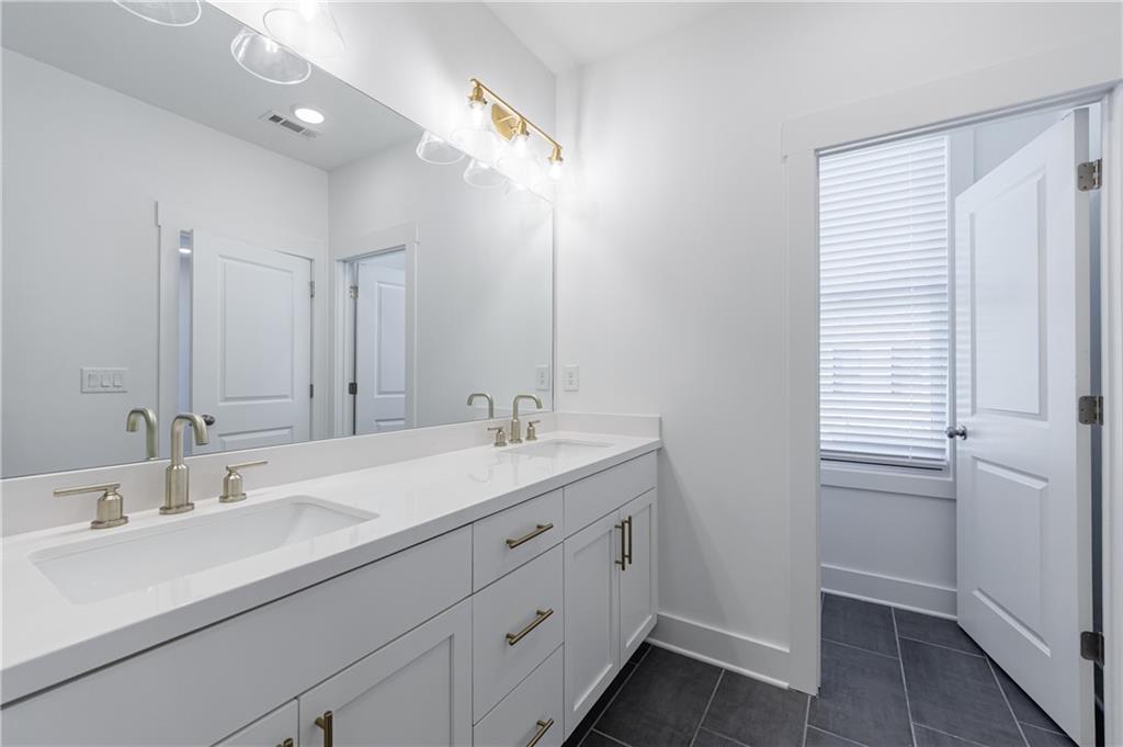 1032 Robert Smalls Way Atlanta, GA 30318 - Photo 44 of 74 a bathroom with a double vanity sink and mirror