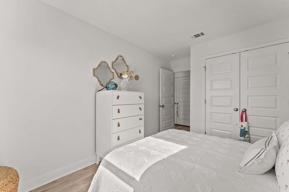 46 Redbird Loop Destin, FL 32541 - Photo 16 of 21 a bedroom with a bed and a chandelier