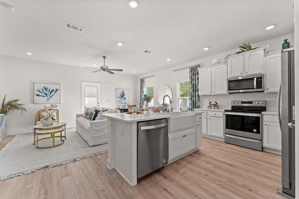 46 Redbird Loop Destin, FL 32541 - Photo 3 of 21 a kitchen with stainless steel appliances kitchen island granite countertop a stove a sink and a refrigerator