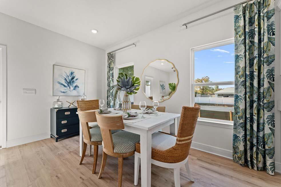 46 Redbird Loop Destin, FL 32541 - Photo 6 of 21 a dining room with furniture a large window and wooden floor