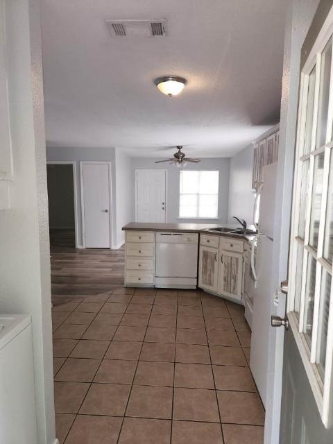 2203 Monroe Street, Unit B Commerce, TX 75428 - Photo 3 of 6 a kitchen with a sink a counter top space and appliances