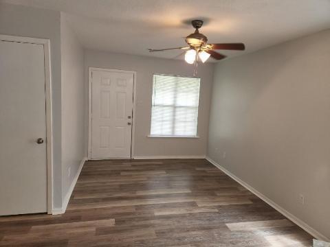 2203 Monroe Street, Unit B Commerce, TX 75428 - Photo 5 of 6 a view of an empty room with wooden floor and a window