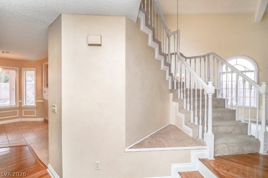 1429 Hawkwood Road Henderson, NV 89014 - Photo 15 of 53 An elegant staircase features classic wood balusters and custom detailed trim.