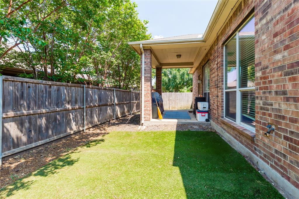 3729 Cook Court Fort Worth, TX 76244 - Photo 20 of 24 a view of a backyard with a small cabin and wooden fence