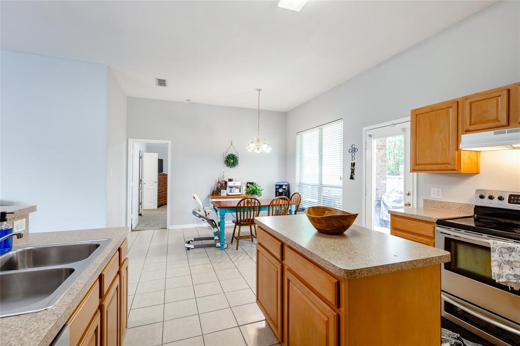 3729 Cook Court Fort Worth, TX 76244 - Photo 7 of 24 a kitchen with a sink and chairs