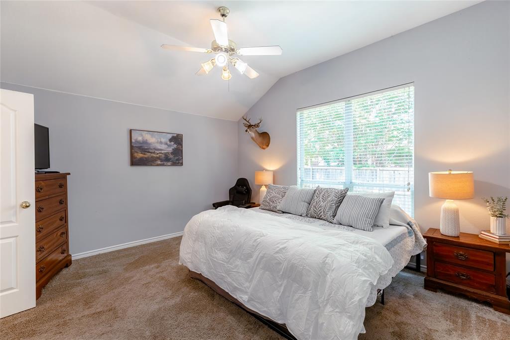 3729 Cook Court Fort Worth, TX 76244 - Photo 9 of 24 a bedroom with a bed and a chandelier