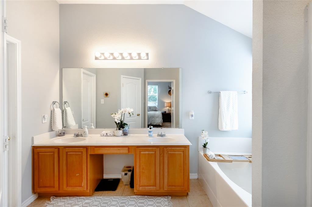 3729 Cook Court Fort Worth, TX 76244 - Photo 10 of 24 a bathroom with a tub sink and mirror