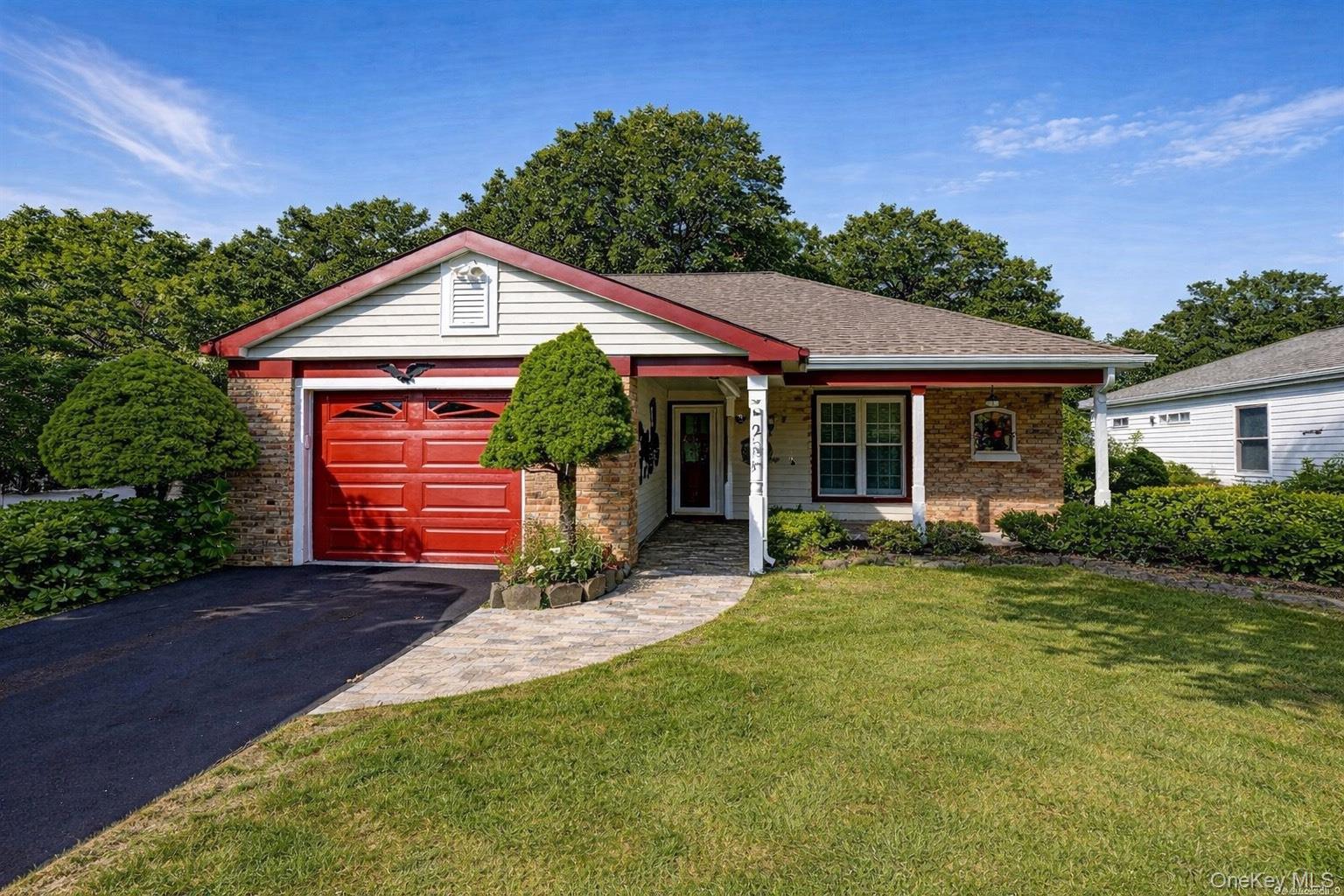2 Bedford Court Ridge, NY 11961 - Photo 1 of 12 a front view of a house with a yard and porch