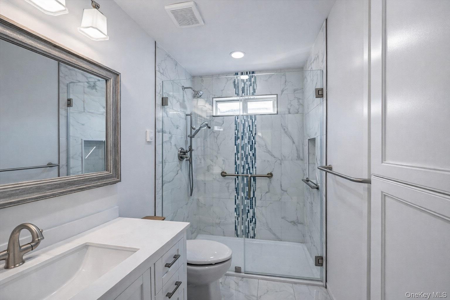 2 Bedford Court Ridge, NY 11961 - Photo 7 of 12 a bathroom with a sink toilet and shower