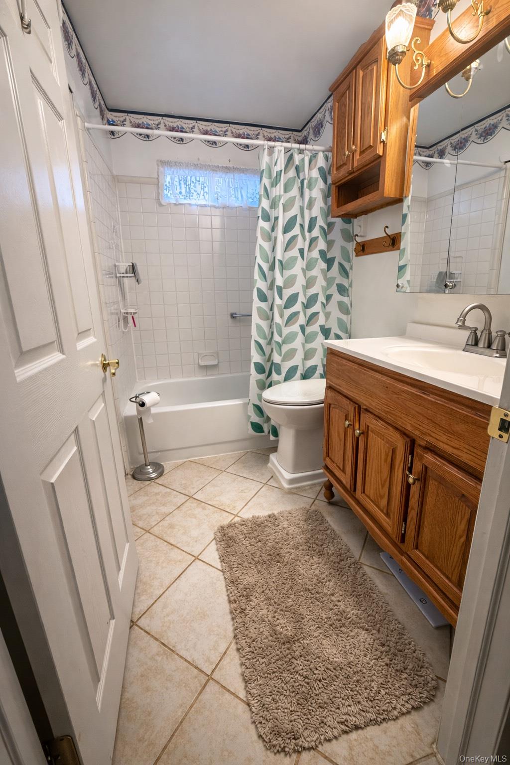 2 Bedford Court Ridge, NY 11961 - Photo 9 of 12 a bathroom with a sink a toilet and shower