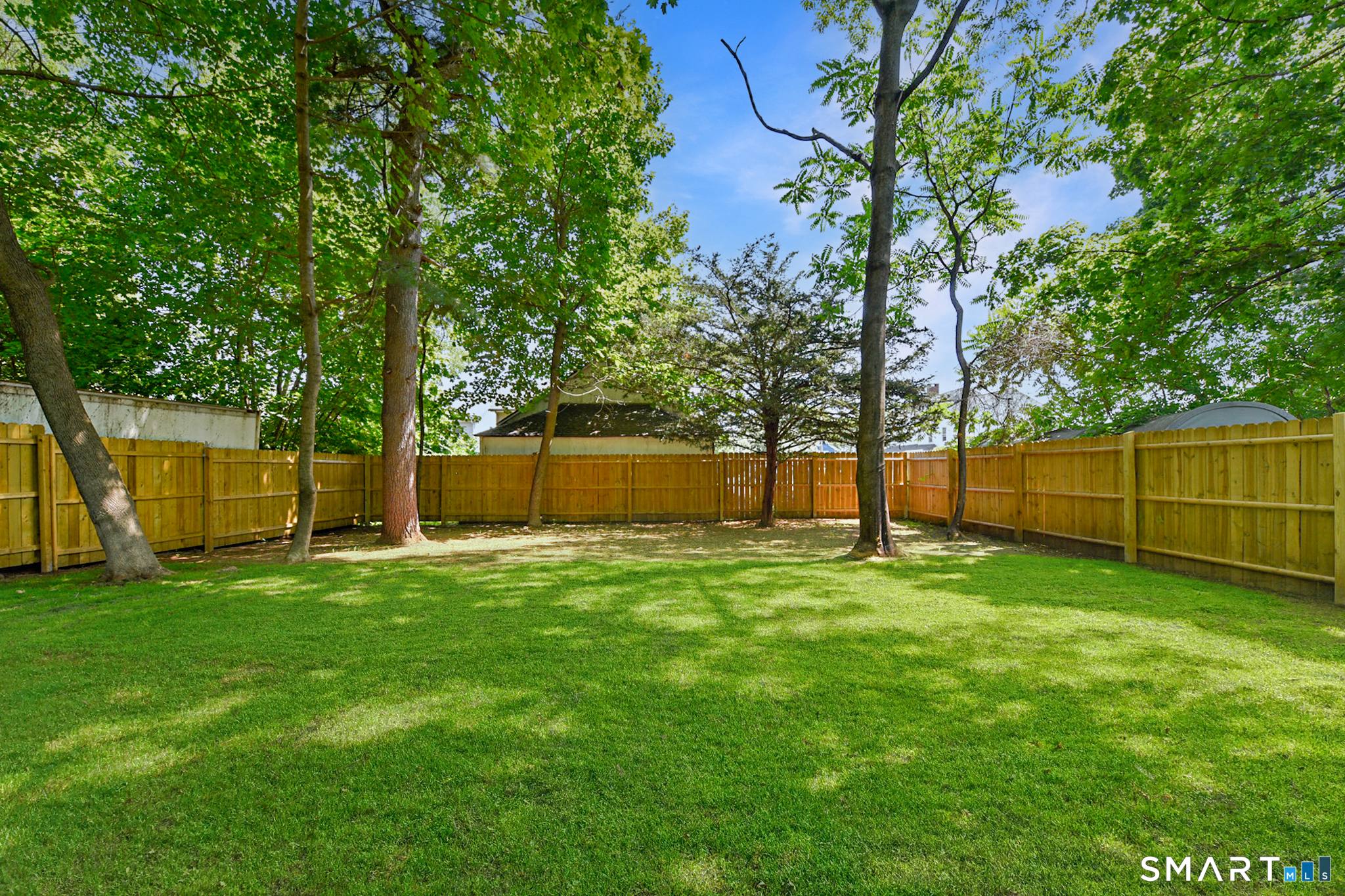 63 Park Road Hamden, CT 06517 - Photo 32 of 39 Beautiful yard with recently planted grass and NEW wood panel fence!