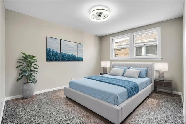 a bedroom with a bed and a potted plant