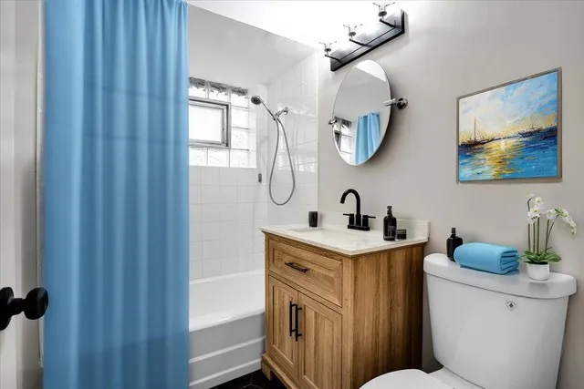 a bathroom with a toilet a sink and a mirror