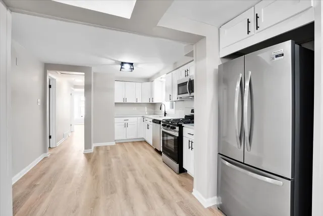 a kitchen with stainless steel appliances a refrigerator stove and sink