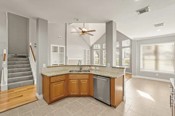 a kitchen with a sink stove and cabinets