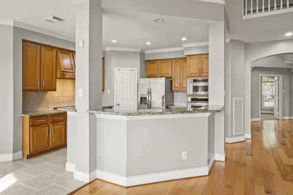 a kitchen with stainless steel appliances granite countertop a stove a sink and a refrigerator