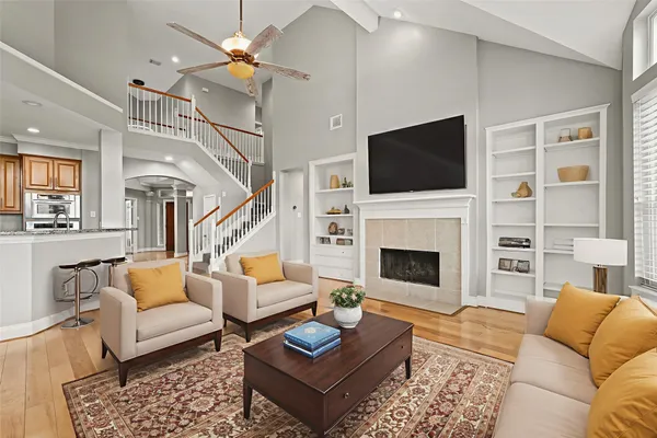 a living room with furniture fireplace and flat screen tv