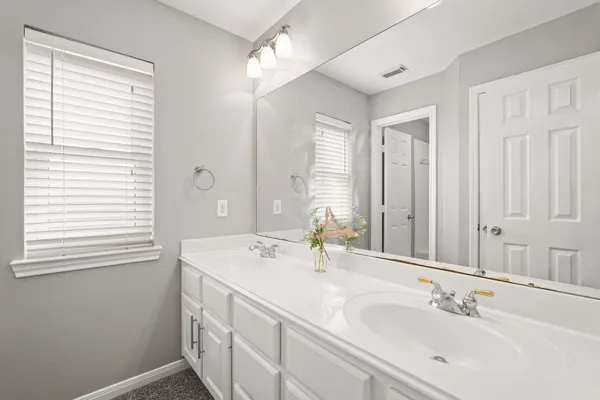 a bathroom with 2 sink and a mirror