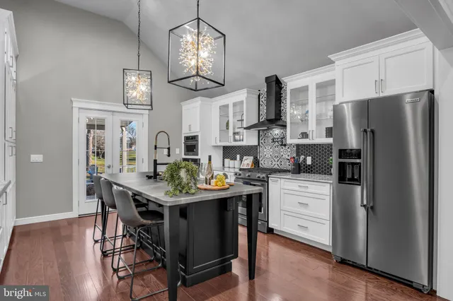 a kitchen with stainless steel appliances granite countertop a sink and cabinets