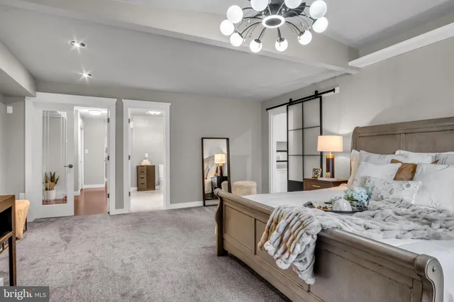a view of a hallway with wooden floor and stairs