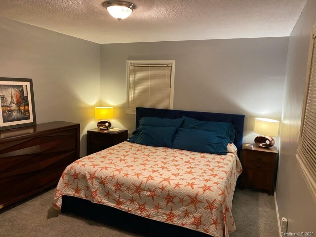 448 Union Cemetery Road Southwest Concord, NC 28027 - Photo 22 of 36 a bed sitting in a bedroom and a night stand