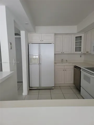 a kitchen with kitchen island cabinets and oven