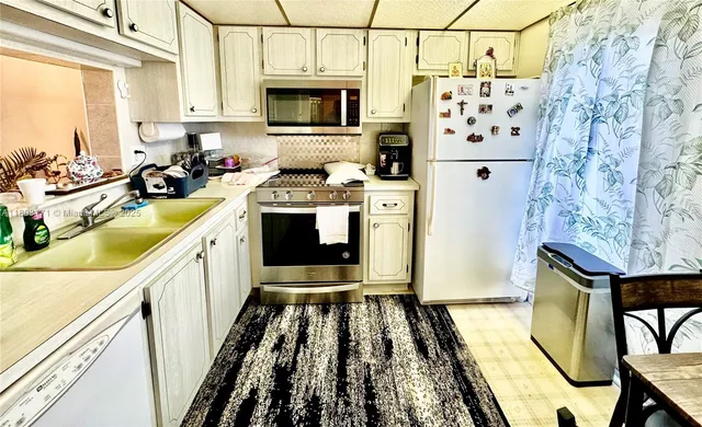 a kitchen with stainless steel appliances granite countertop a stove and a refrigerator