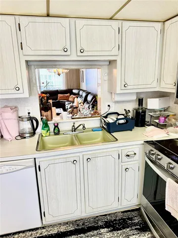 a kitchen with white cabinets and white appliances