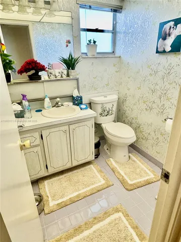 a bathroom with a sink toilet and vanity