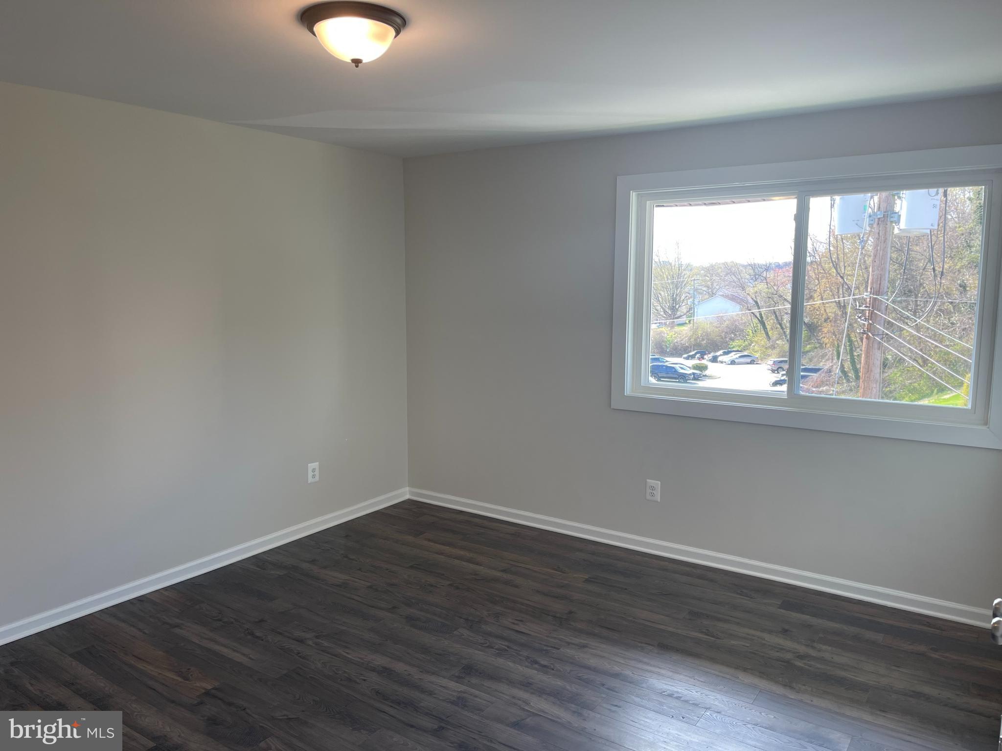 3142 Brinkley Road, Unit 6304 Temple Hills, MD 20748 - Photo 14 of 15 wooden floor in an empty room with a window