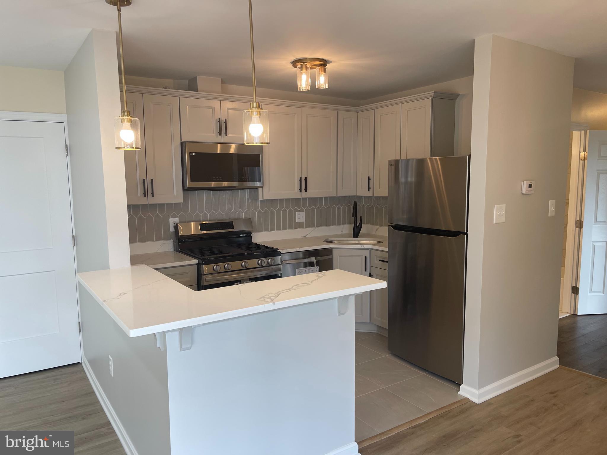 3142 Brinkley Road, Unit 6304 Temple Hills, MD 20748 - Photo 15 of 15 a kitchen with a refrigerator and a sink