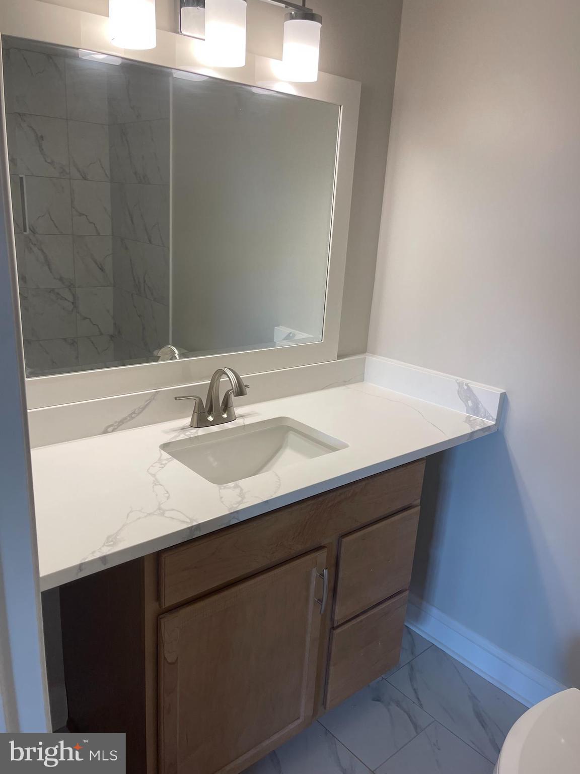 3142 Brinkley Road, Unit 6304 Temple Hills, MD 20748 - Photo 2 of 15 a sink with a mirror