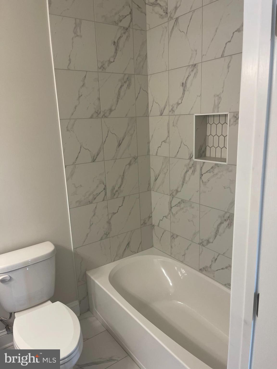 3142 Brinkley Road, Unit 6304 Temple Hills, MD 20748 - Photo 5 of 15 a bathroom with a toilet and bathtub