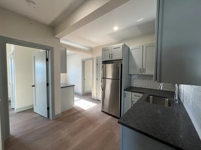 a kitchen with a refrigerator and a sink