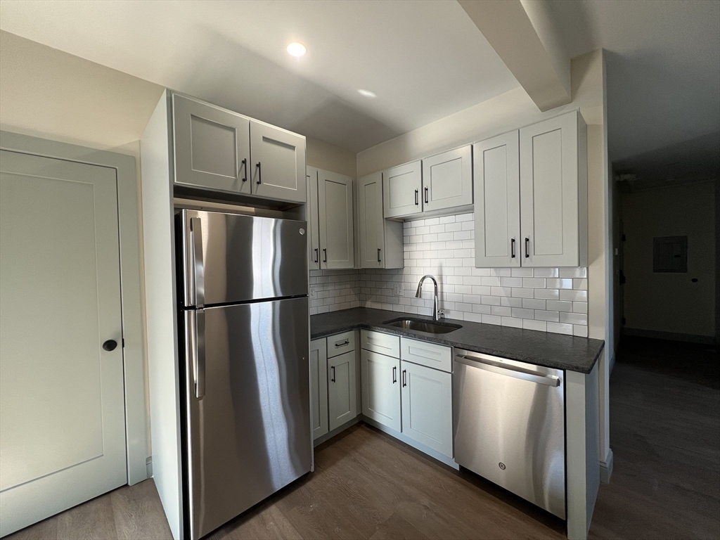 160 Seabury Street, Unit 15 Fall River, MA 02720 - Photo 2 of 10 a kitchen with stainless steel appliances granite countertop a refrigerator a sink and white cabinets