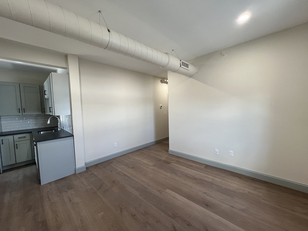 160 Seabury Street, Unit 15 Fall River, MA 02720 - Photo 7 of 10 an empty room with a cabinet and a mirror