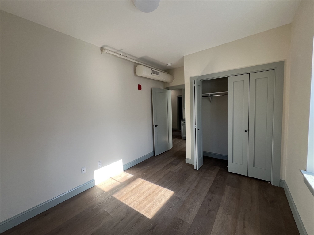 160 Seabury Street, Unit 15 Fall River, MA 02720 - Photo 9 of 10 an empty room with wooden floor and closet