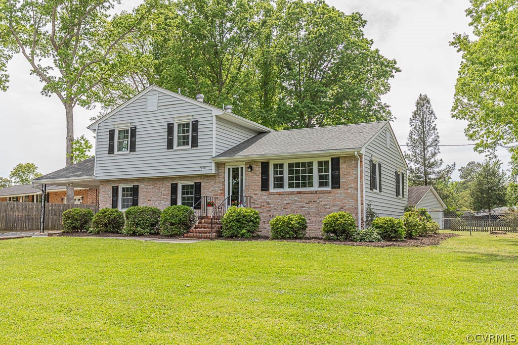7800 Bronze Lane Prince George, VA 23875 - Photo 2 of 30 a front view of a house with a garden