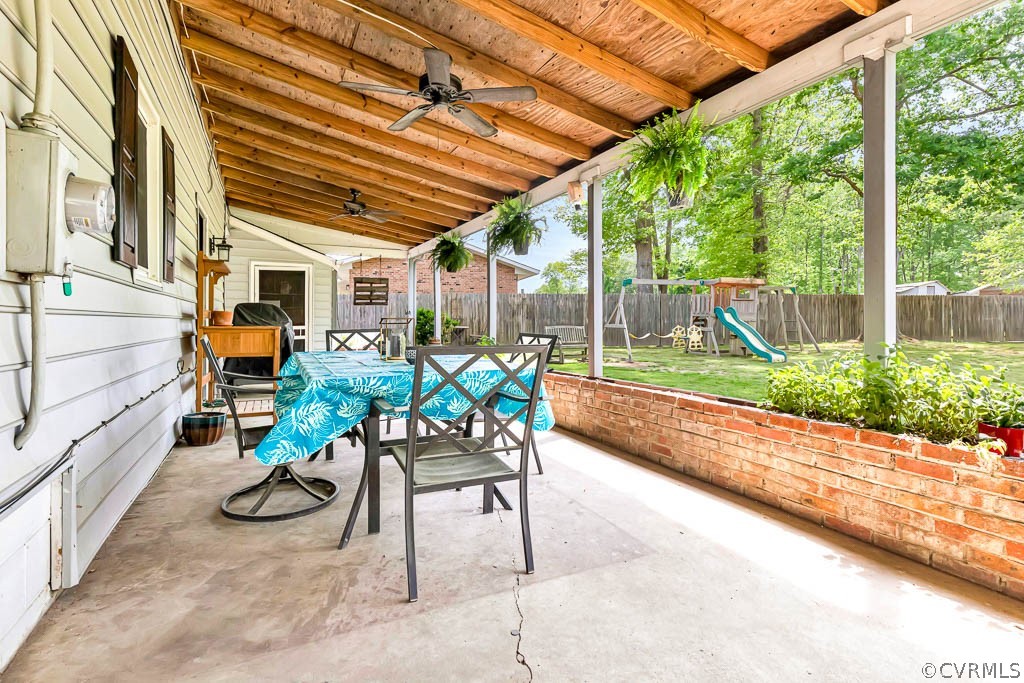 7800 Bronze Lane Prince George, VA 23875 - Photo 25 of 30 a porch with a table and chairs and potted plants