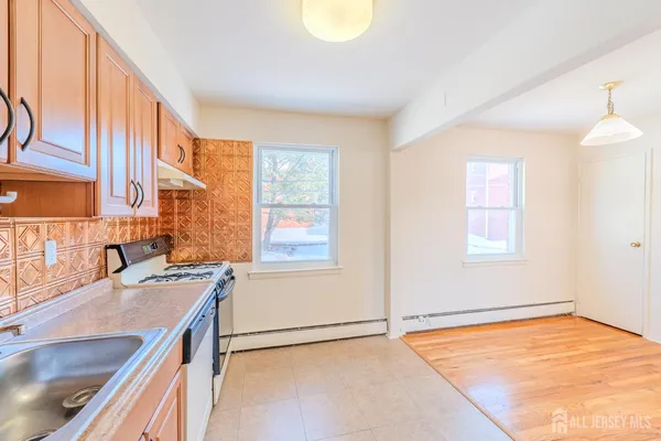 a kitchen with a sink stove and cabinets