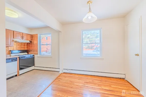 a view of a kitchen with a stove cabinets and wooden floor