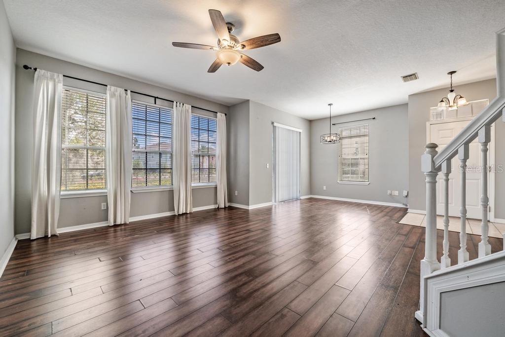 8512 Shallow Creek Court New Port Richey, FL 34653 - Photo 12 of 45 a view of an empty room with wooden floor and a window