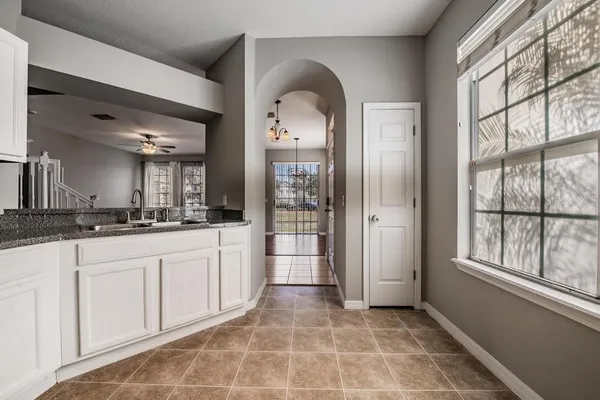 a large bathroom with a large mirror vanity and a shower