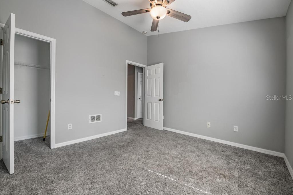 8512 Shallow Creek Court New Port Richey, FL 34653 - Photo 23 of 45 an empty room with a chandelier fan and closet