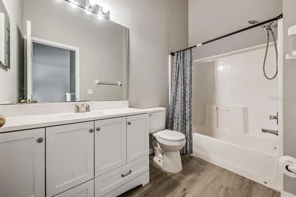 a bathroom with a sink toilet a shower and a mirror